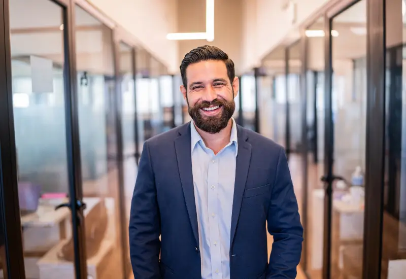 A man who has had cosmetic dentistry work done smiles in his Parker, CO office