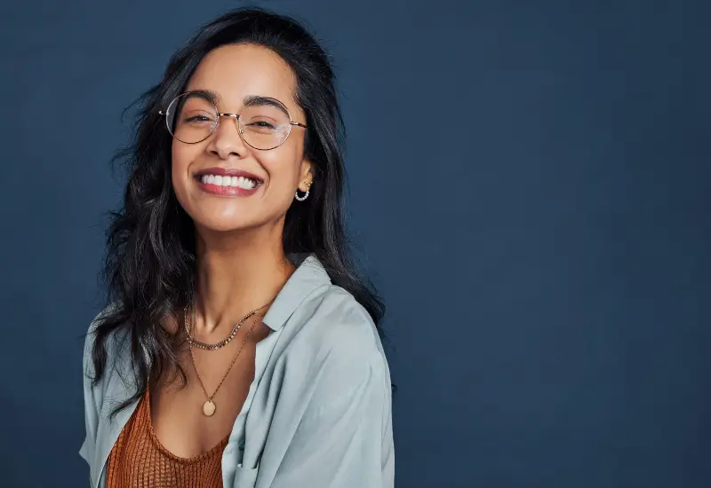 A woman who has had professional teeth-whitening smiles at the camera in Parker, CO