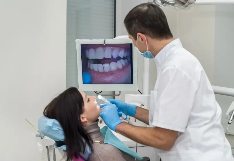 A dentist uses an advanced intraoral camera on a patient in Parker, CO